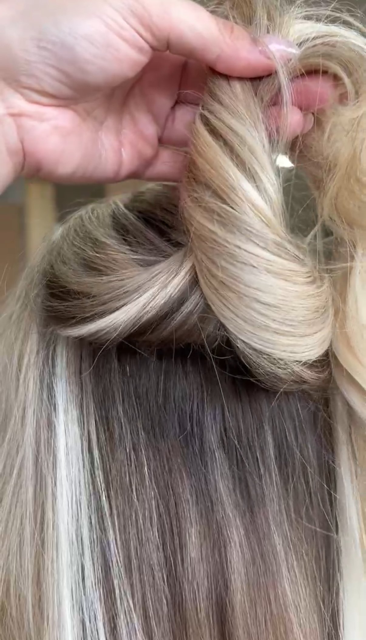 Close-up of a Luna Method hand-tied weft install at Fringe Beauty Studio